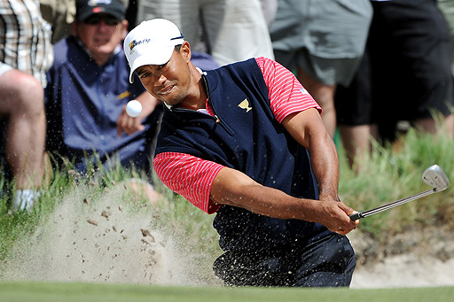 Tiger Woods plays out of a bunker