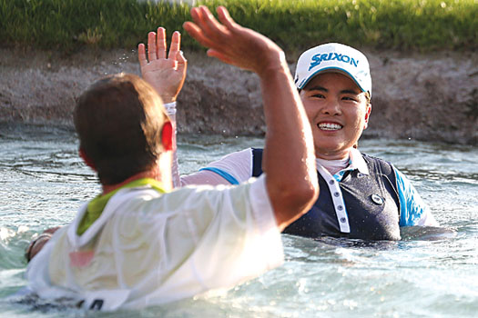 Celebrating with her caddie after claiming the Kraft Nabisco Championship