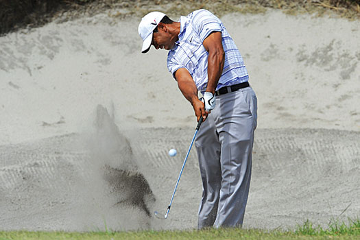 Tiger Woods plays from one of Royal Melbourne’s splendidly designed bunkers