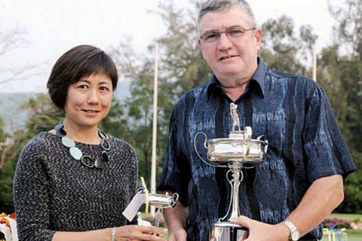 Donald Nimmo receives the coveted silverware from Mrs Sidney Cheng