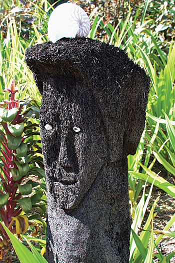 One of the many carved and decorated black tree fern trunks