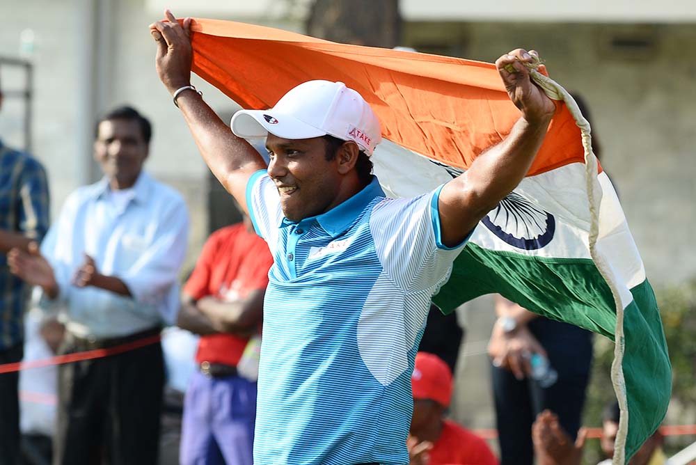 S.S.P Chawrasia holds up the national flag after winning his first European Tour Indian Open title on home soil in 2016