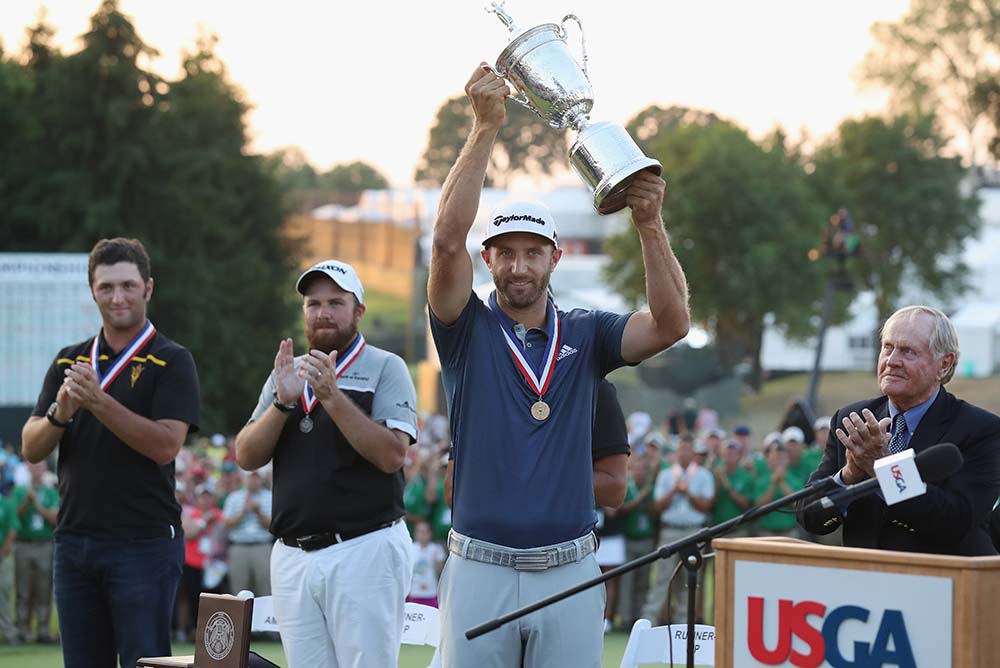 Dustin Johnson poses with the winner's trophy after winning the U.S. Open at Oakmont Country Club last year
