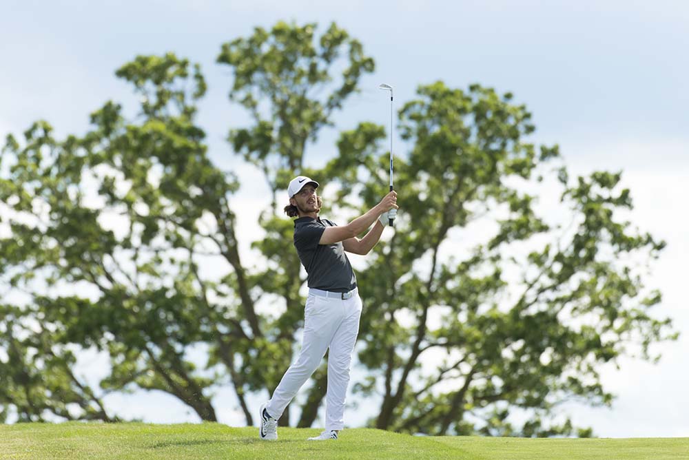 Tommy Fleetwood hits his second shot on the 8th during the final round