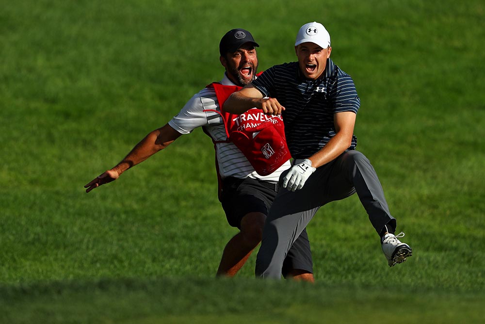 Jordan Spieth celebrates with caddie Michael Greller