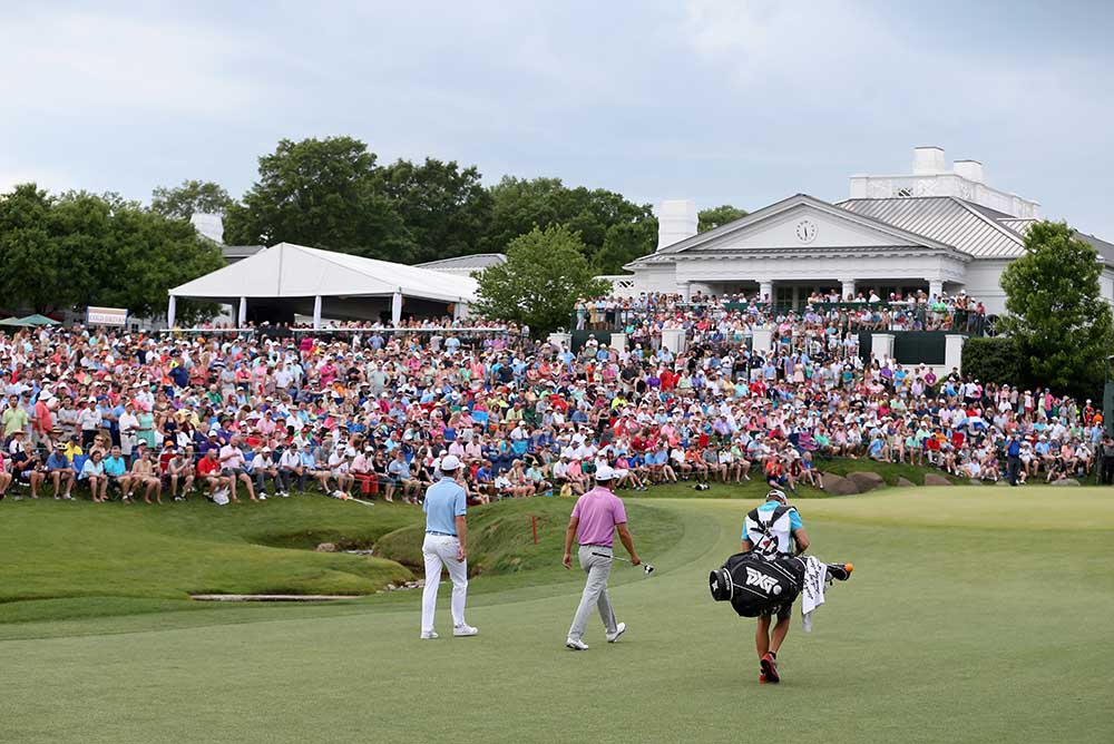 Justin Rose and James Hahn walk up the 18th fairway