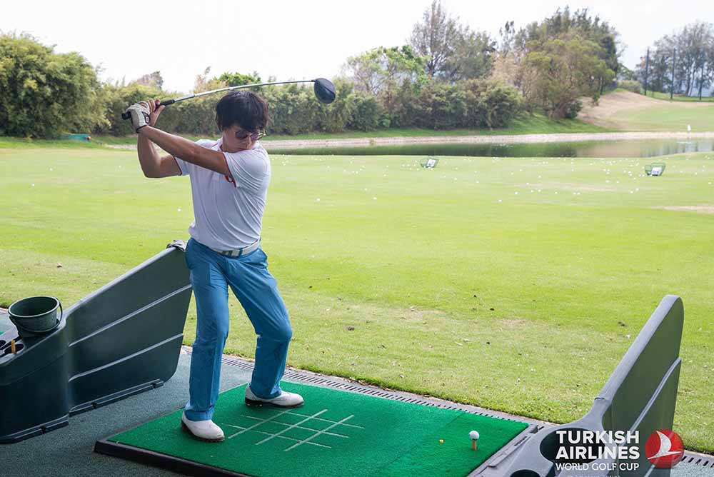 Louie Chan, our Managing Editor, warms up at the driving range