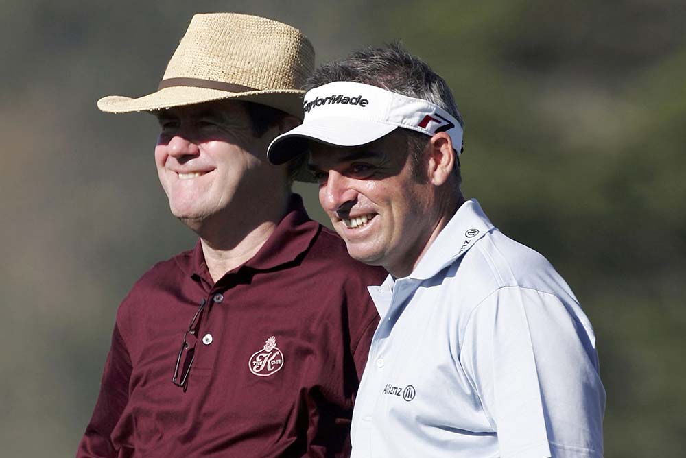 Paul McGinley laughs with businessman J.P. McManus of Ireland