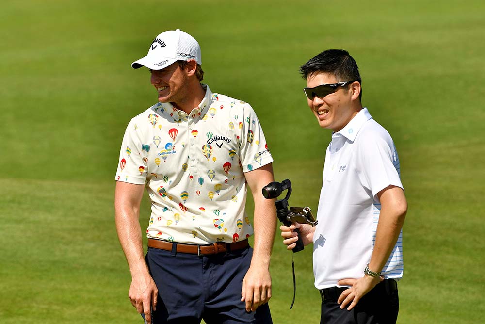 Calvin Koh (right) talks with Australia’s Todd Sinnott