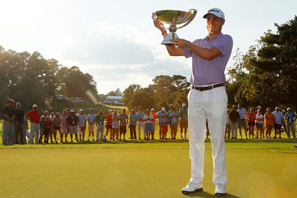 Justin Thomas celebrates after winning the FedExCup