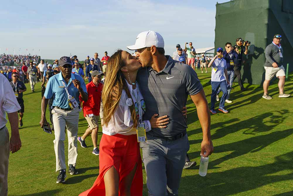 Brooks Koepka kisses his girlfriend after winning