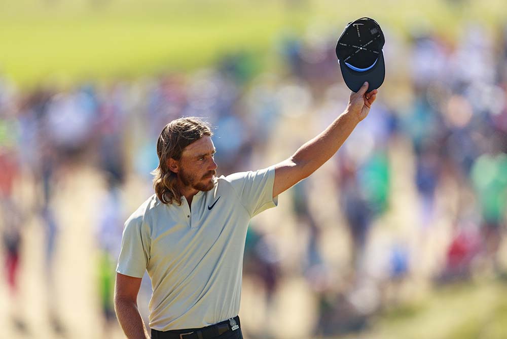 Fleetwood waves to the crowd on the 18th green