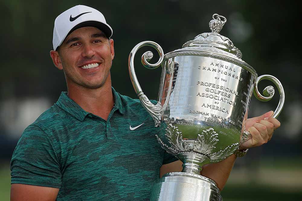 Brooks Koepka poses with the Wanamaker Trophy