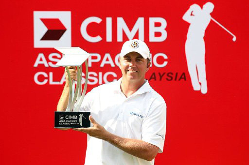 Bo Van Pelt poses with the championship trophy after his six-shot victory