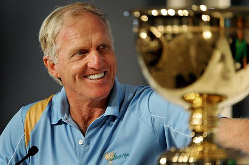Greg Norman smiles in front of the President's Cup Trophy