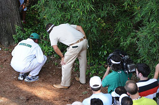 Phil Mickelson looks at the position of his ball on the fourth hole, Sunday at the Masters.  Mickelson went on to make a triple-bogey 6 on the hole.