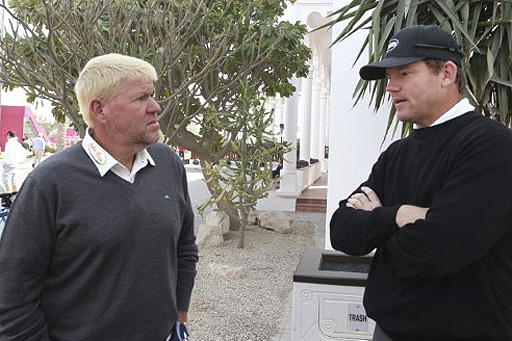 John Daly (left) talks with Paul Lawrie of Scotland (right) as play was suspended Friday