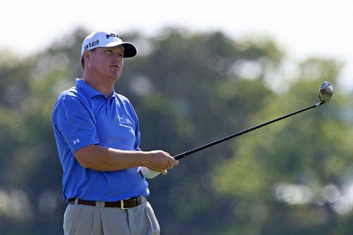 Joint leader Chad Campbell watches his tee shot on 18