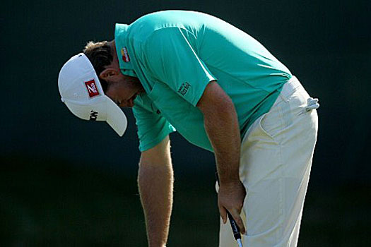 Graeme McDowell reacts to a missed birdie putt on the 11th hole