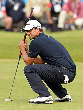 Adam Scott reacts after missing his putt on the 18th green