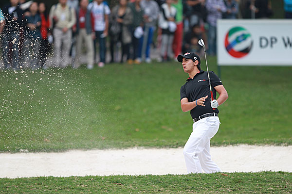 Matteo Manassero hits a bunker shot on the 13th hole