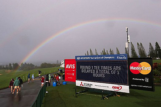 A rainbow is seen over the Plantation Course during a weather delay