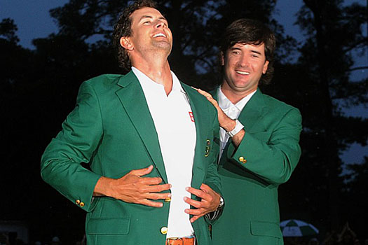 Adam Scott receives the Green Jacket from Bubba Watson