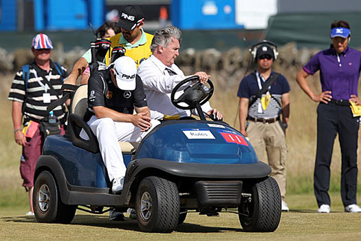 Louis Oosthuizen sits in a buggy after he withdrew from The Open