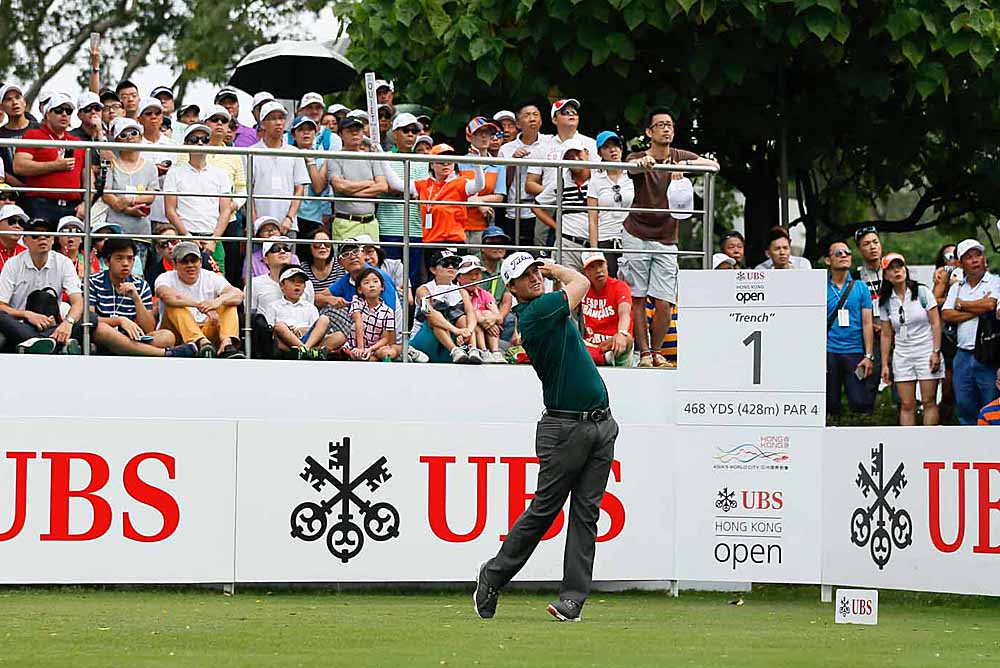 Athena (in checkered skirt, seated in first row) watches Lucas Bjerregaard tee off