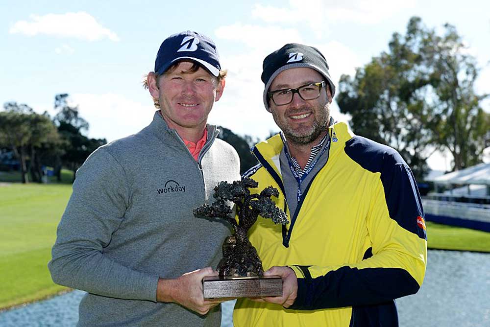 Brandt Snedeker and caddie Scott Vail pose with the winner's trophy