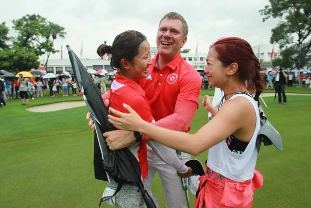 Tiffany hugs with coach Brad and best mate Stephanie Ho